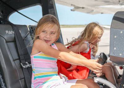 Two young girls at the controls of a small aircraft at Girls in Aviation Day