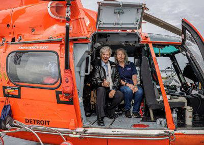 Visitors sit inside the Coast Guard helicopter