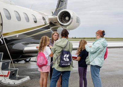 Visitors line up to board a business jet