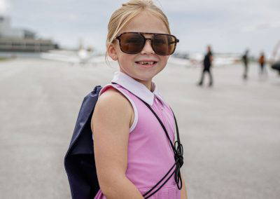 A girl in sunglasses smiles on the ramp