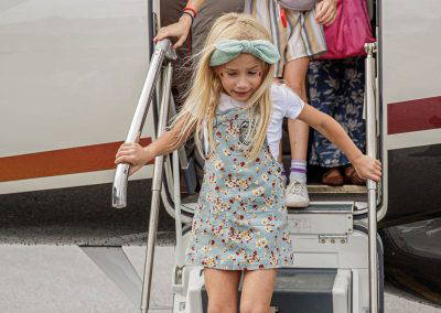 A girl climbs down the jet stairs