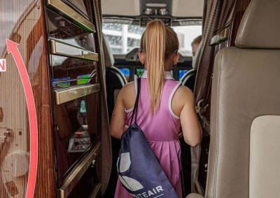 A girl walks through the cabin of a business jet