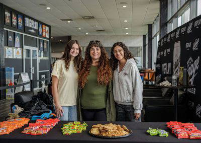 Three volunteers at the snack table