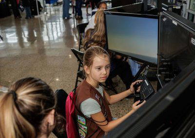 A girl flies a flight simulator