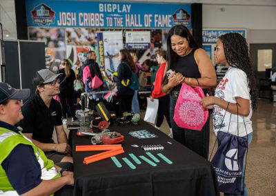 Visitors try an activity at an exhibitor table