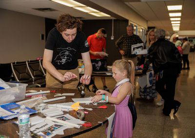 A girl works on a hands-on craft