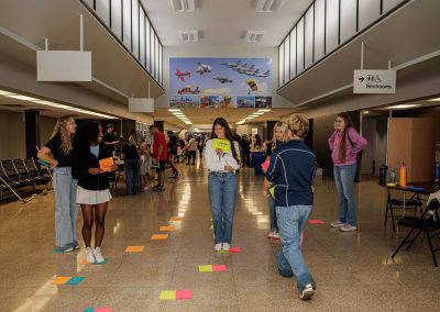 Girls play a floor game in the terminal