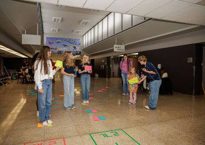 Girls take turns at a floor game