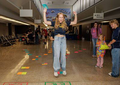 A girl celebrates during a floor game