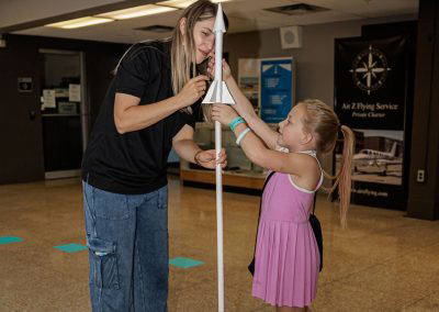 A volunteer and a girl at a hands-on activity
