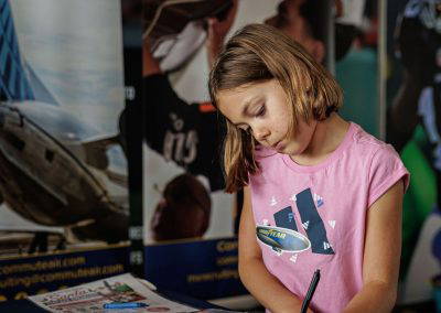 A girl writes at an activity table