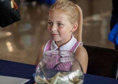 A smiling girl at the donation table