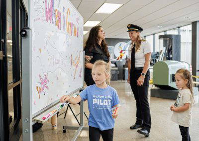 Kids add their dreams to the When I Grow Up whiteboard
