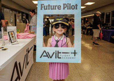 A girl in aviator glasses poses in the Future Pilot photo frame